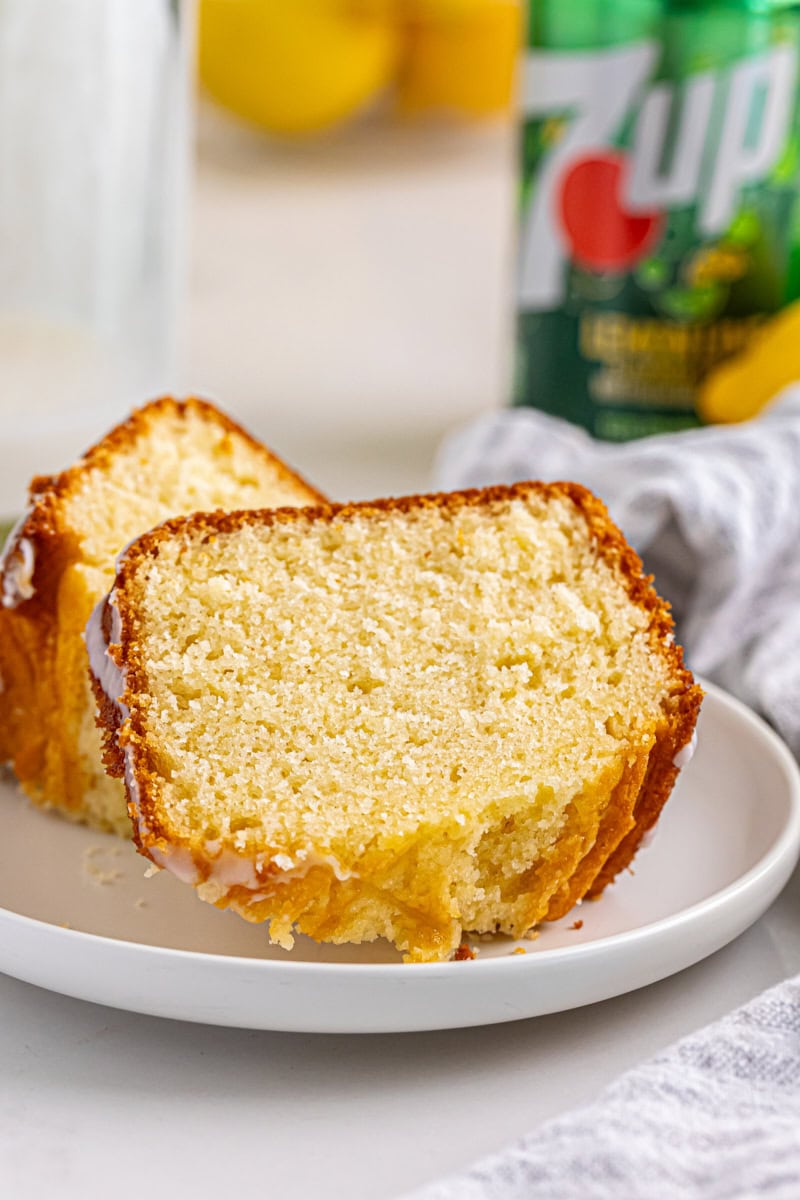 two slices of 7UP cake on a white plate with a can of 7UP in the background