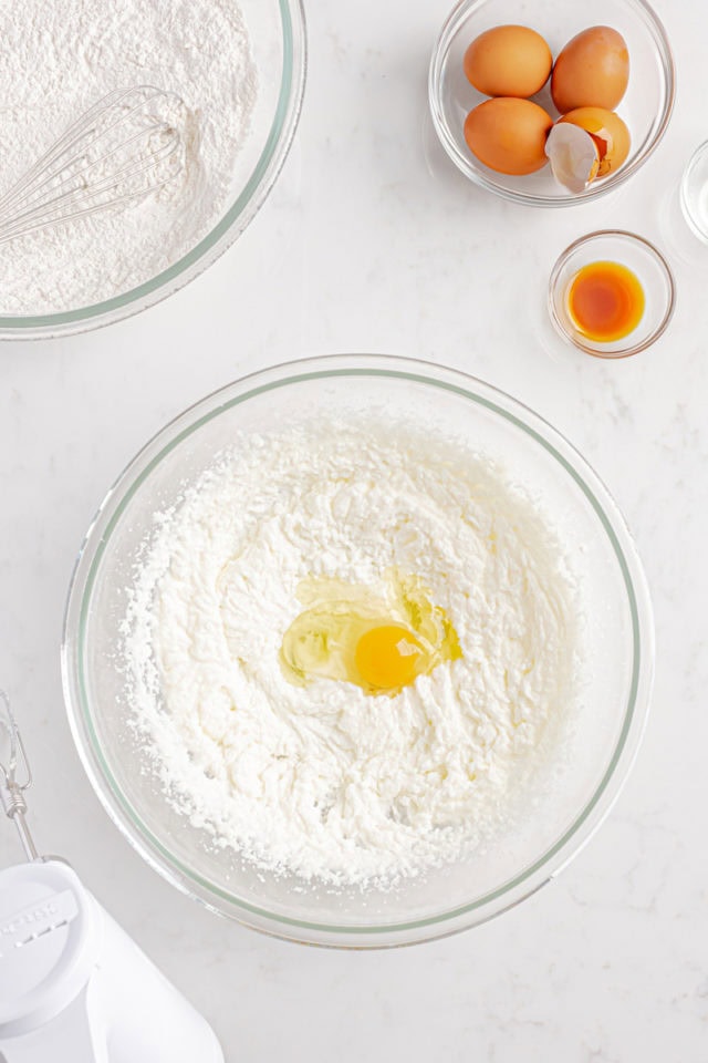 overhead view of egg added to creamed butter, oil, and sugar