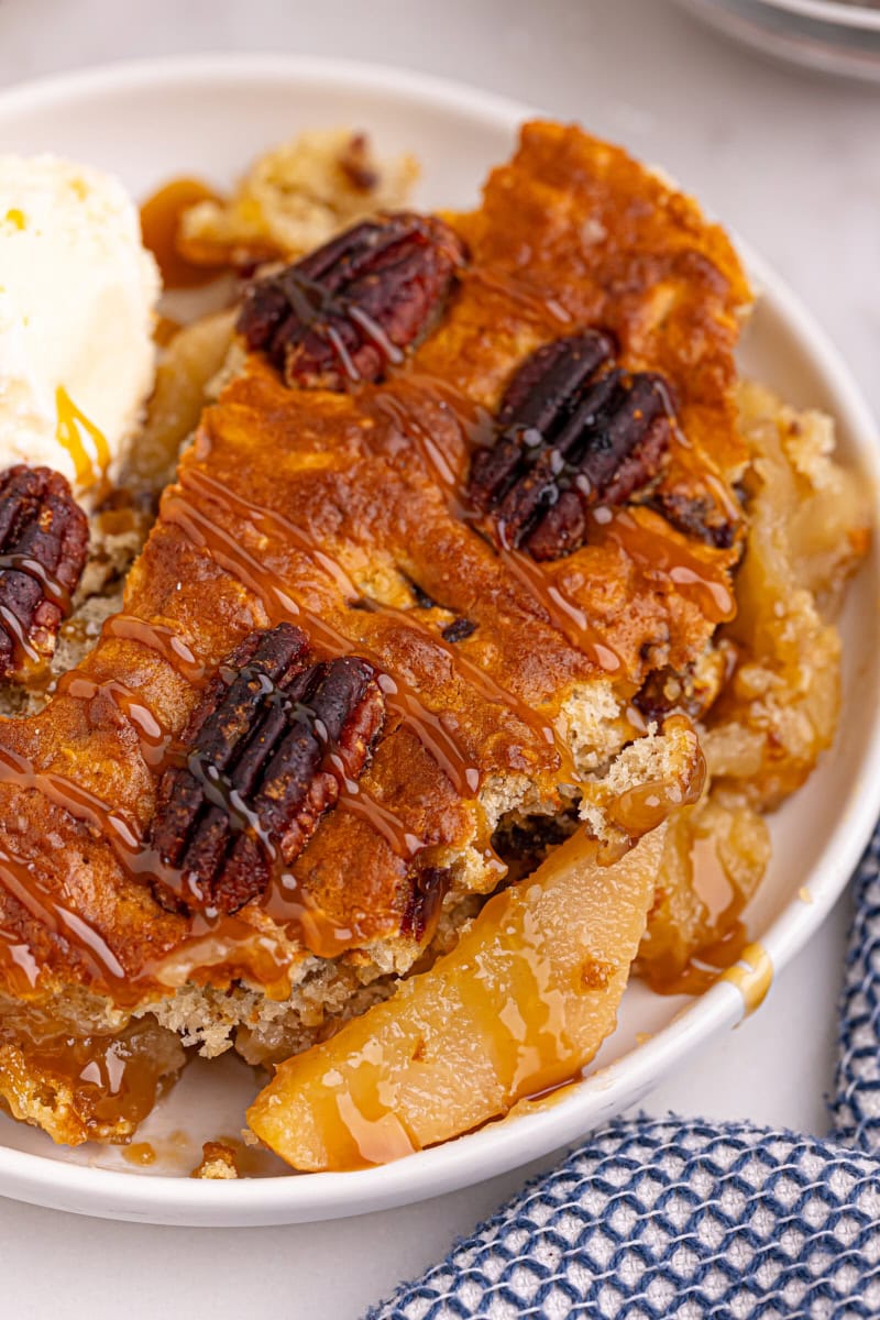 a serving of caramel apple pear cobbler on a white plate