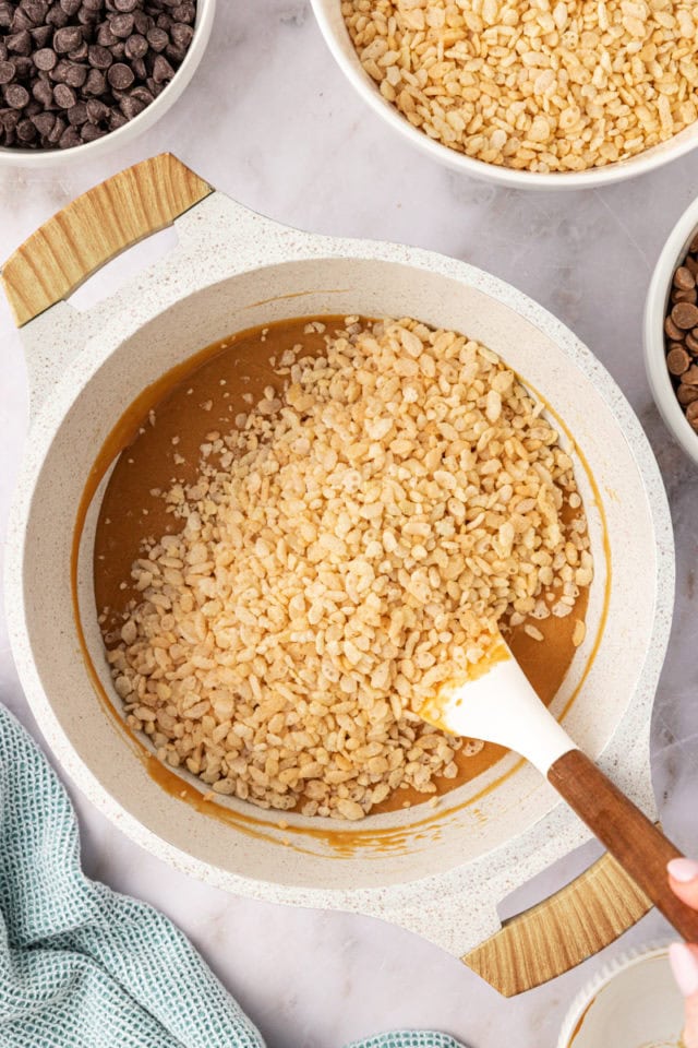 overhead view of crisp rice cereal added to peanut butter mixture