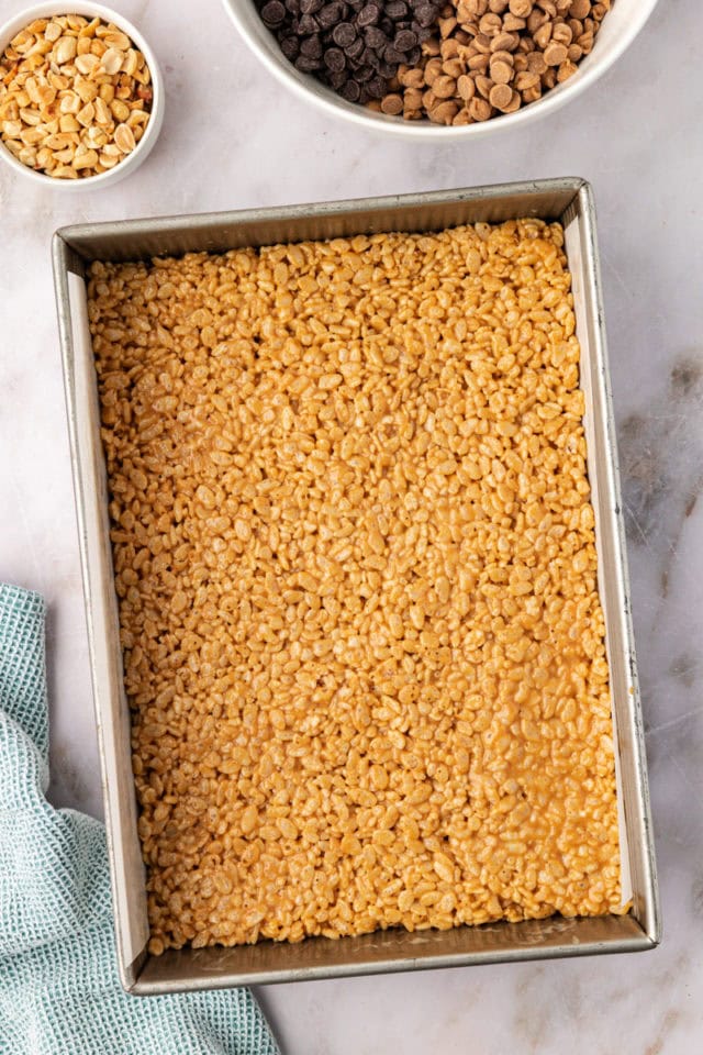 overhead view of peanut butter rice crispy treats spread into a 9x13 pan