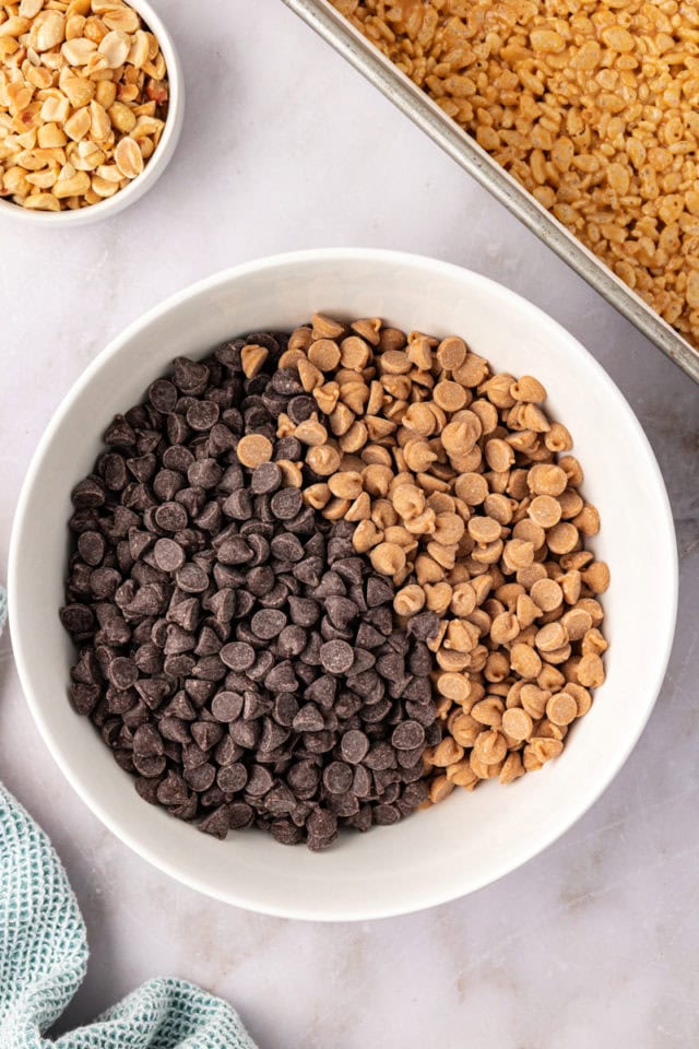 overhead view of chocolate chips and peanut butter chips in a white bowl