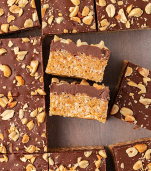 overhead view of chocolate peanut butter rice crispy treats, with some turned on their sides to show their layers