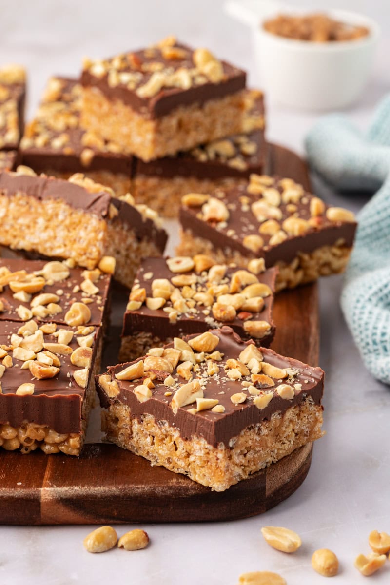 chocolate peanut butter rice crispy treats on a wooden cutting board