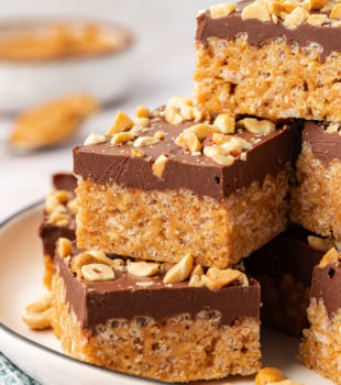 chocolate peanut butter rice crispy treats stacked on a white plate