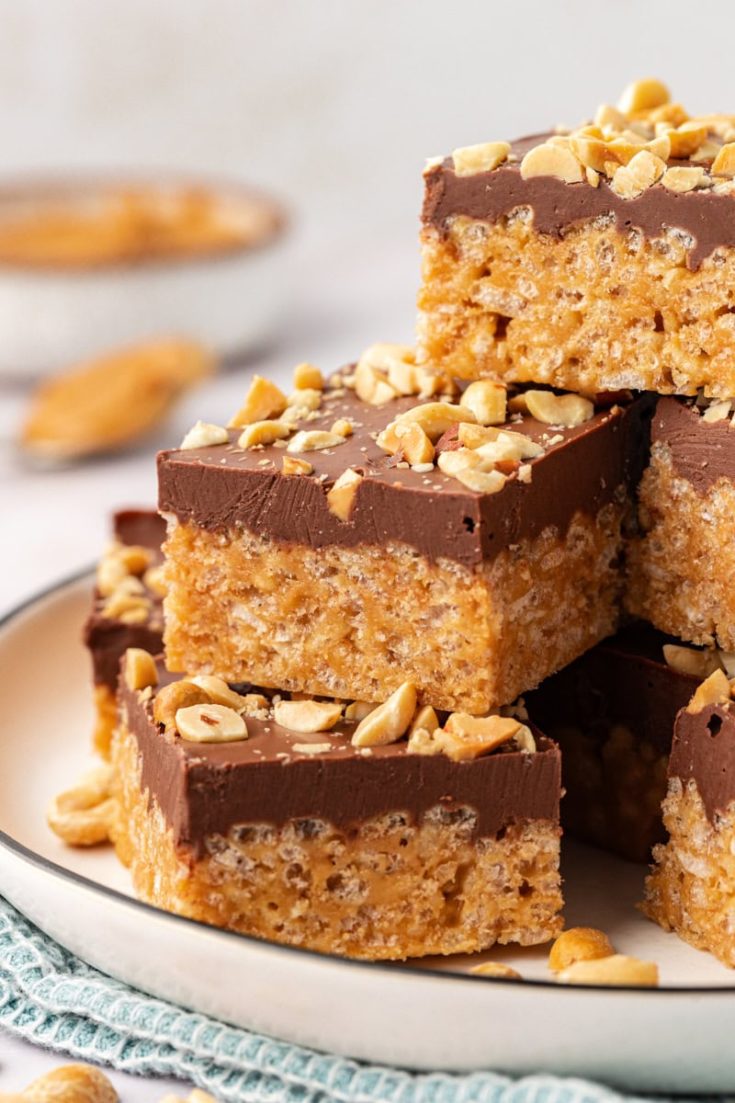 chocolate peanut butter rice crispy treats stacked on a white plate