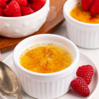 crème brûlée in a ramekin on a white plate