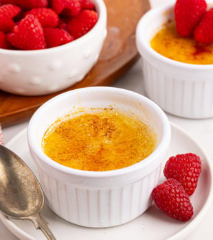 crème brûlée in a ramekin on a white plate