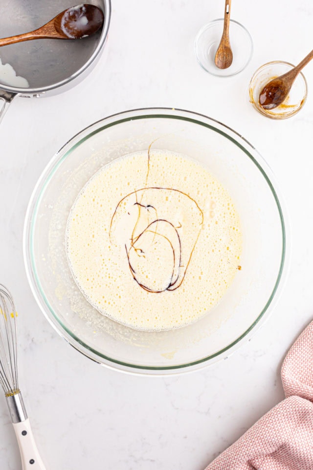 overhead view of vanilla added to crème brûlée mixture