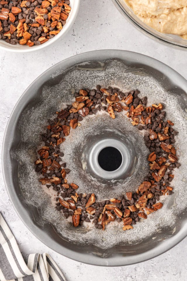 overhead view of chocolate and nut mixture in the bottom of a Bundt pan