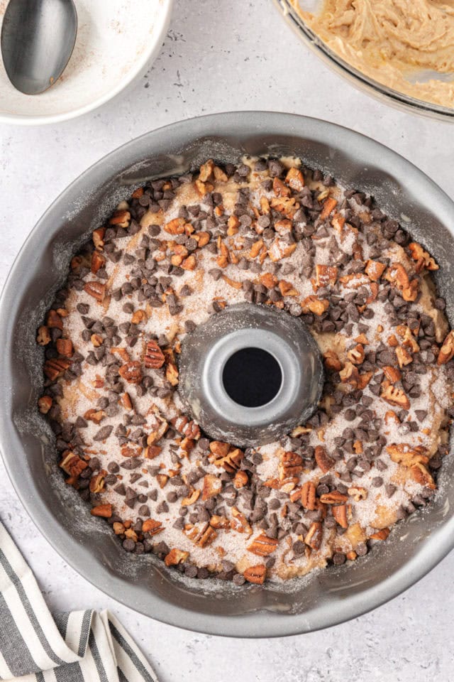 overhead view of second layer of chocolate and nut mixture on top of banana coffee cake batter