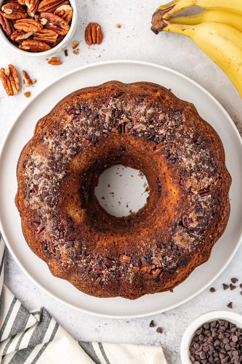 overhead view of banana coffee cake on a white cake plate