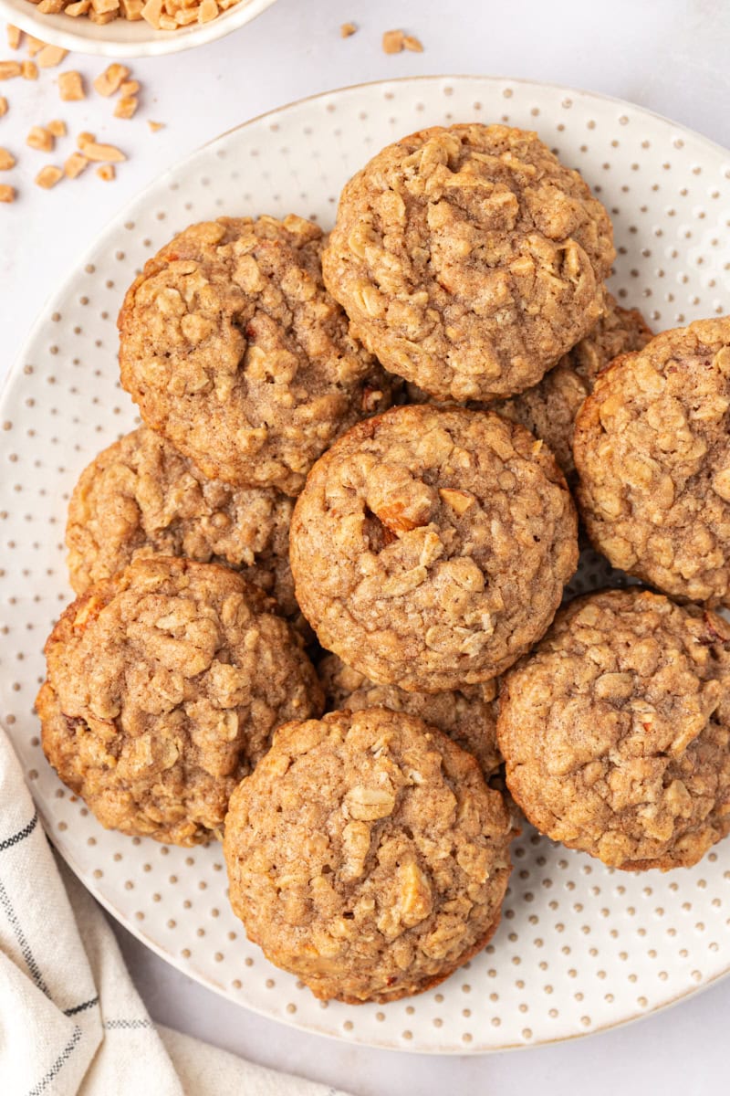 overhead view of toffee almond oatmeal cookies on a white plate