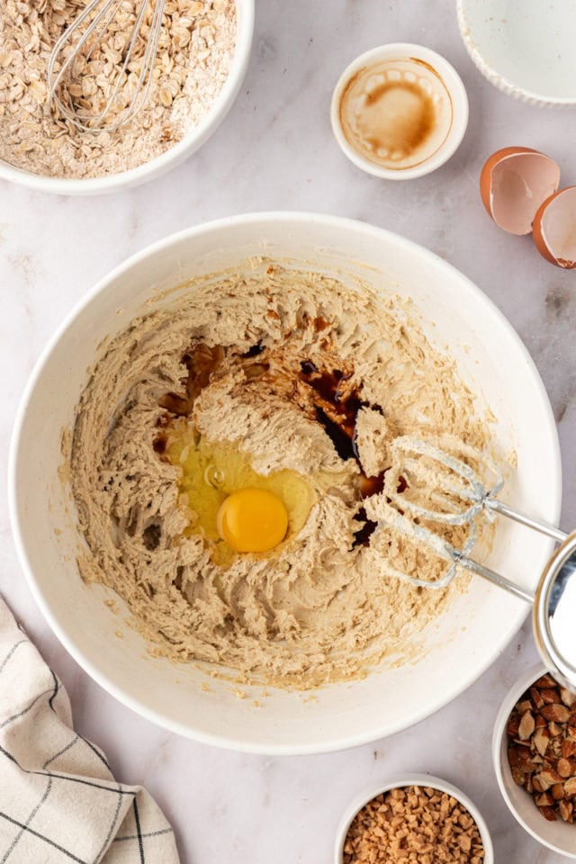 overhead view of egg and vanilla added to creamed butter and sugar