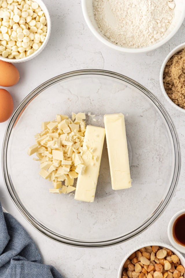 overhead view of butter and white chocolate in a glass mixing bowl