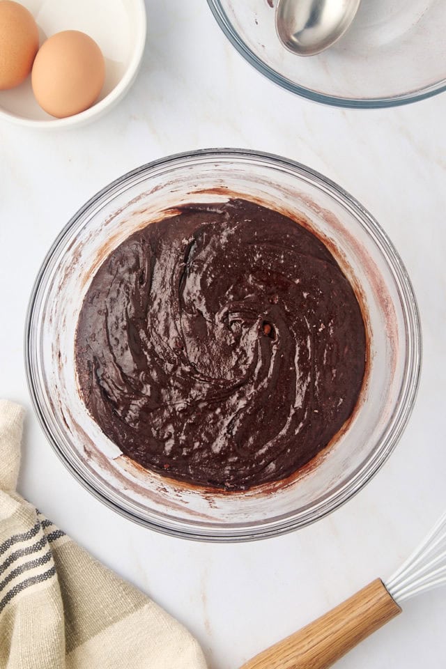 overhead view of brownie batter in a glass mixing bowl