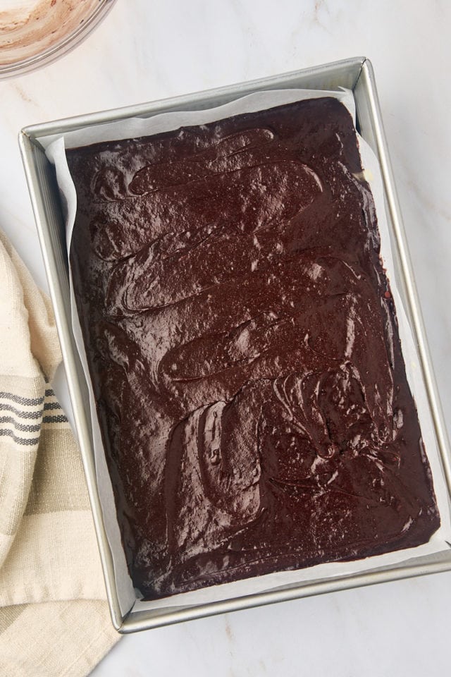 overhead view of brownie batter spread in a 9x13 pan