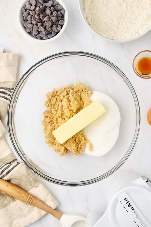 overhead view of butter, sugar, and brown sugar in a glass mixing bowl