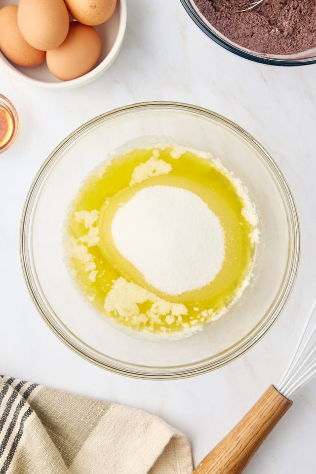 overhead view of melted butter and sugar in a glass mixing bowl