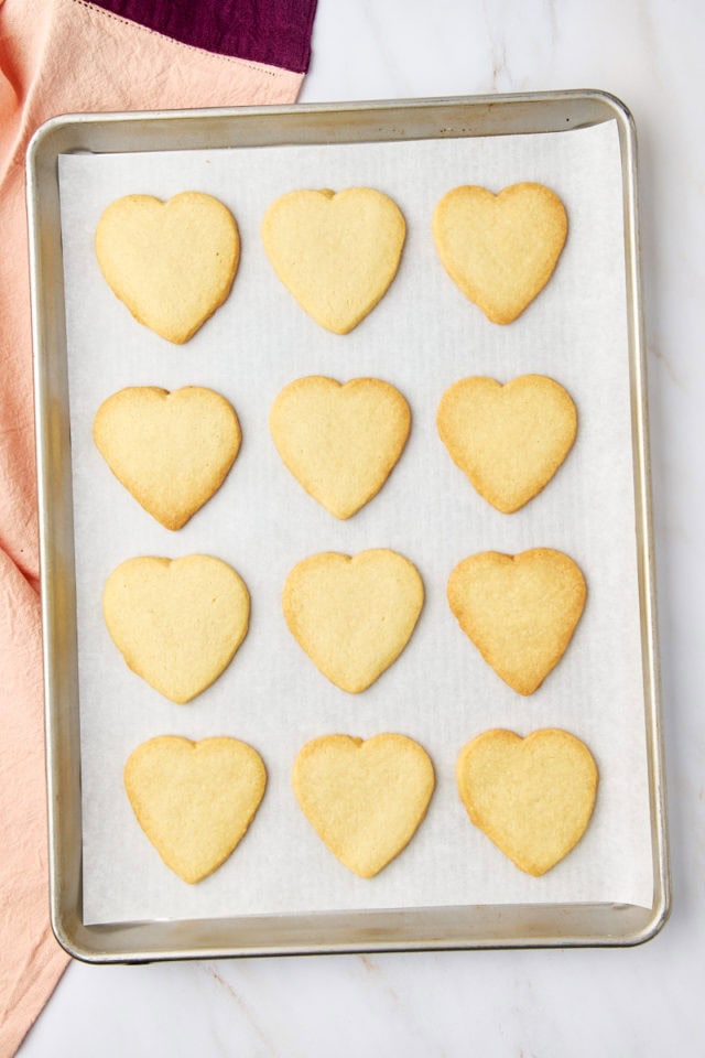 overhead view of freshly baked heart-shaped shortbread cookies