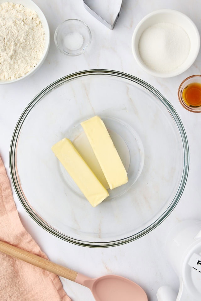 overhead view of softened butter in a glass mixing bowl