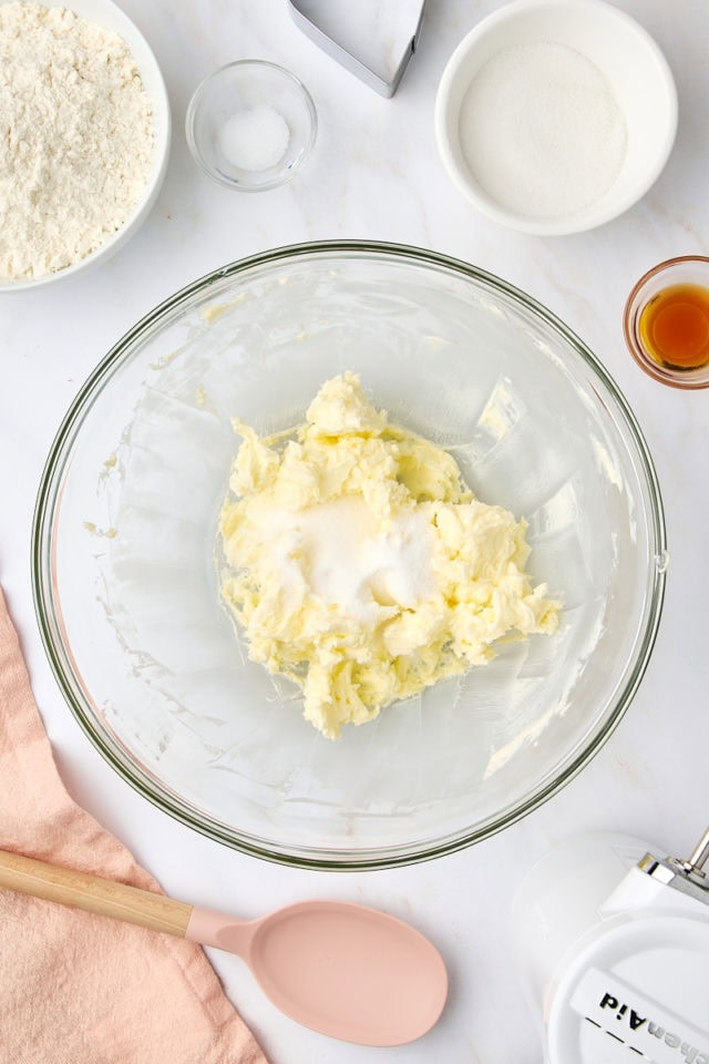 overhead view of sugar added to creamed butter