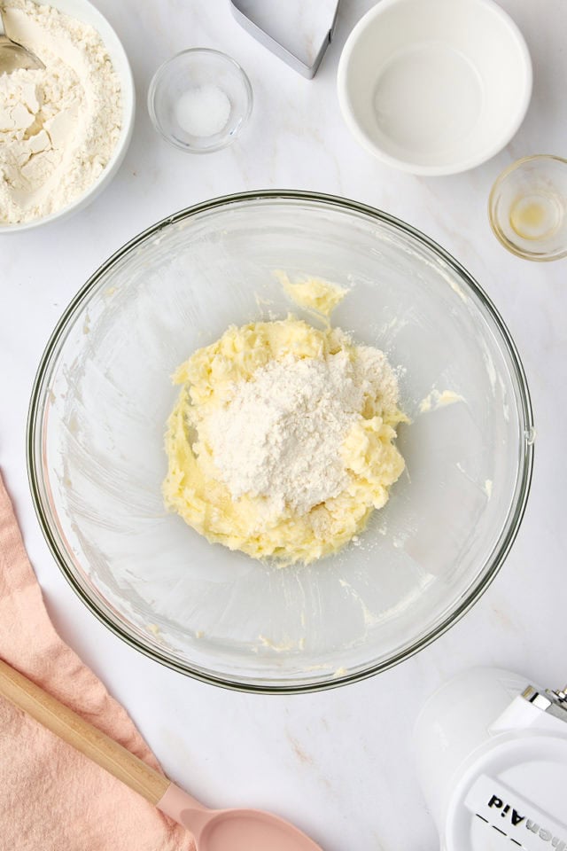 overhead view of flour added to creamed butter and sugar