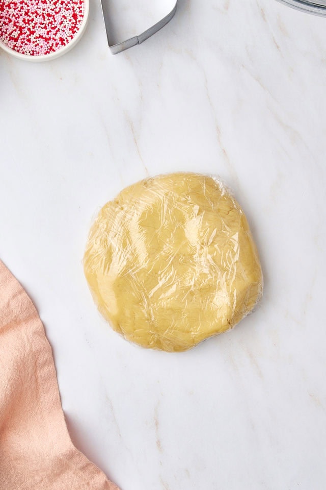 overhead view of shortbread dough wrapped in plastic wrap