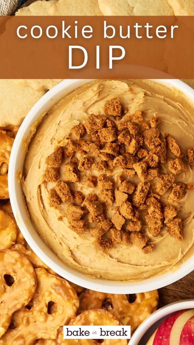 overhead view of cookie butter dip in a bowl surrounded by pretzels, cookies, and apple sliced; text overlay "cookie butter dip"