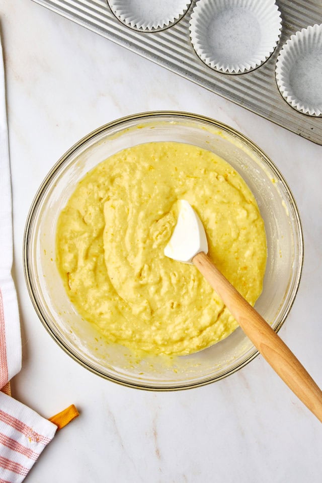 overhead view of orange ricotta muffin batter in a glass mixing bowl