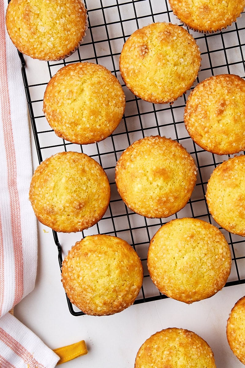 overhead view of orange ricotta muffins on a wire cooling rack