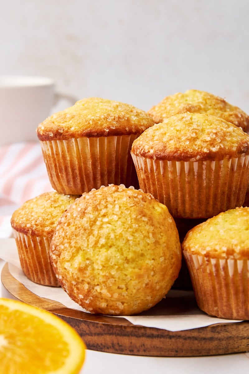 orange ricotta muffins on a wooden serving plate