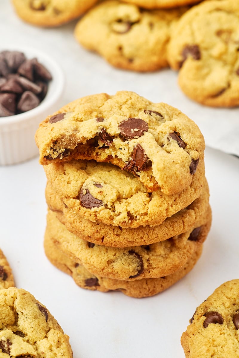 stack of four tahini chocolate chip cookies with a bite missing from the top cookie