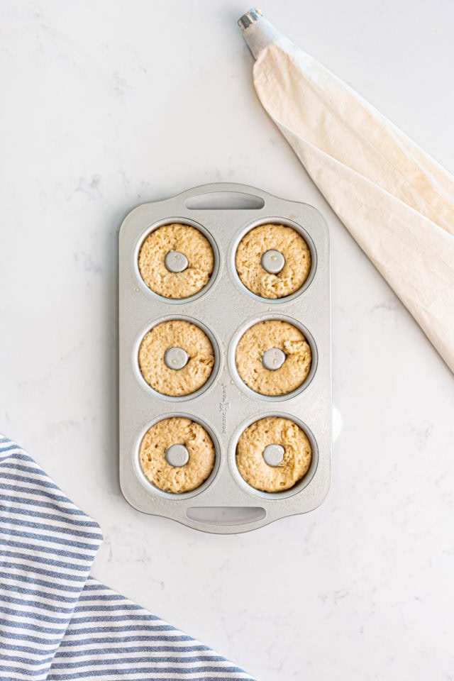 overhead view of baked doughnuts ready to go into the oven