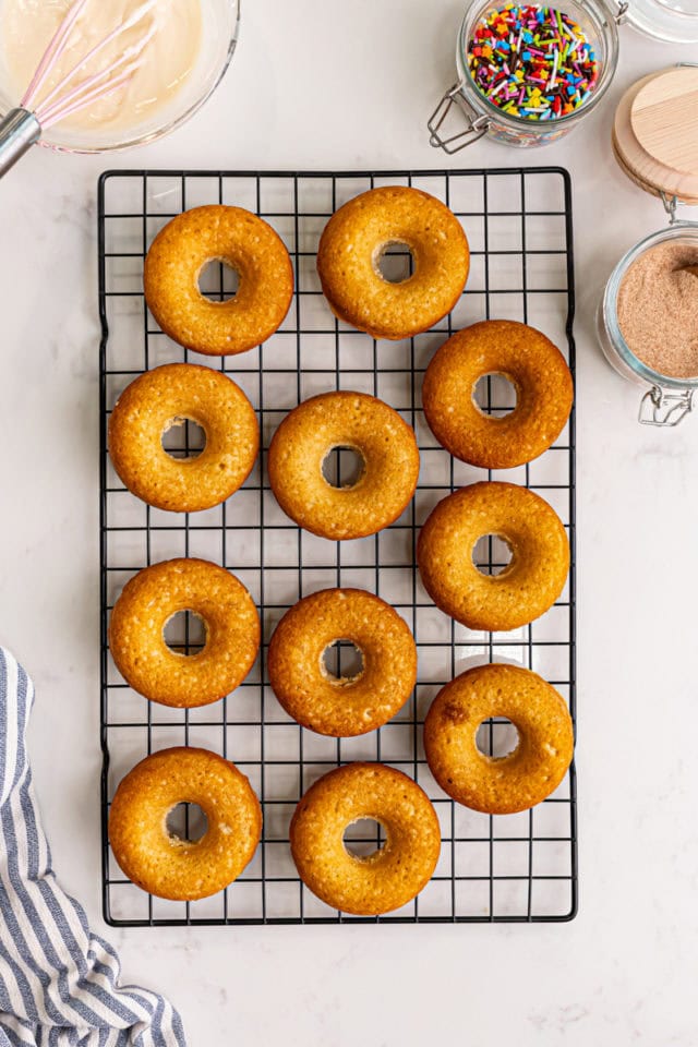 overhead view of freshly baked doughnuts on a wire rack