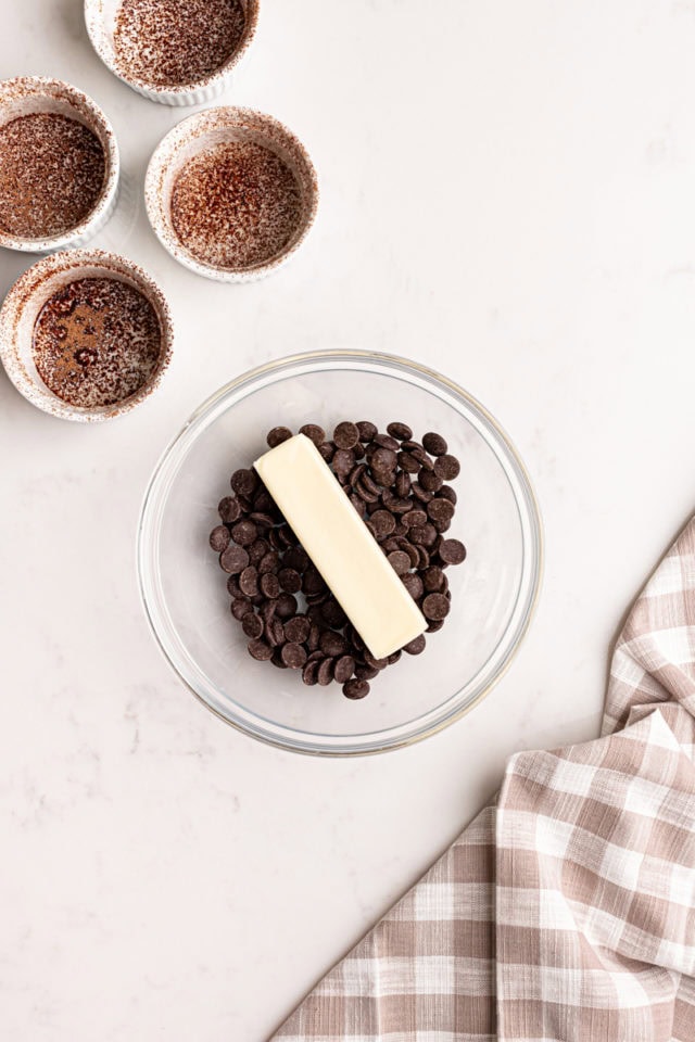 overhead view of chocolate and butter in a glass bowl