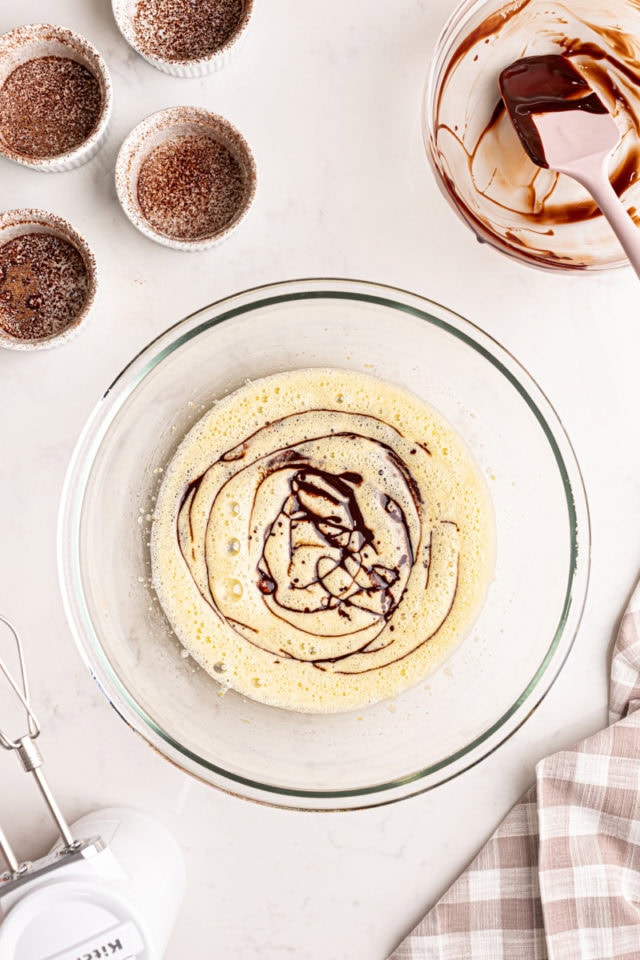 overhead view of melted chocolate and butter mixture added to egg and sugar mixture