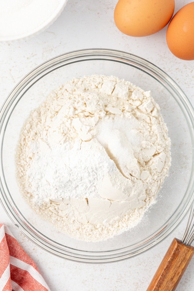 overhead view of flour, baking powder, and salt in a mixing bowl