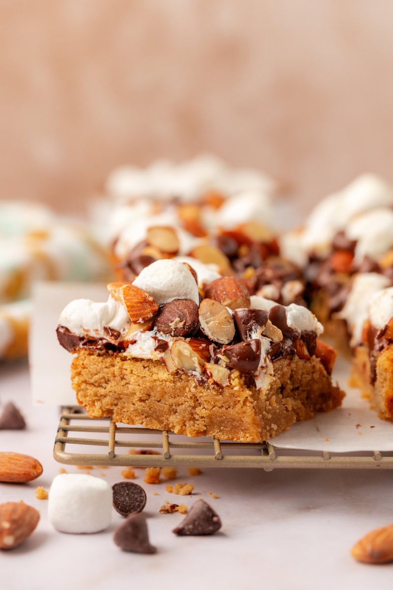 a peanut butter rocky road bar on a wire rack, surrounded by more bars