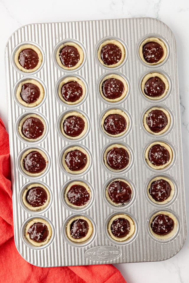 overhead view of brownie tassies in a mini muffin pan ready to go into the oven