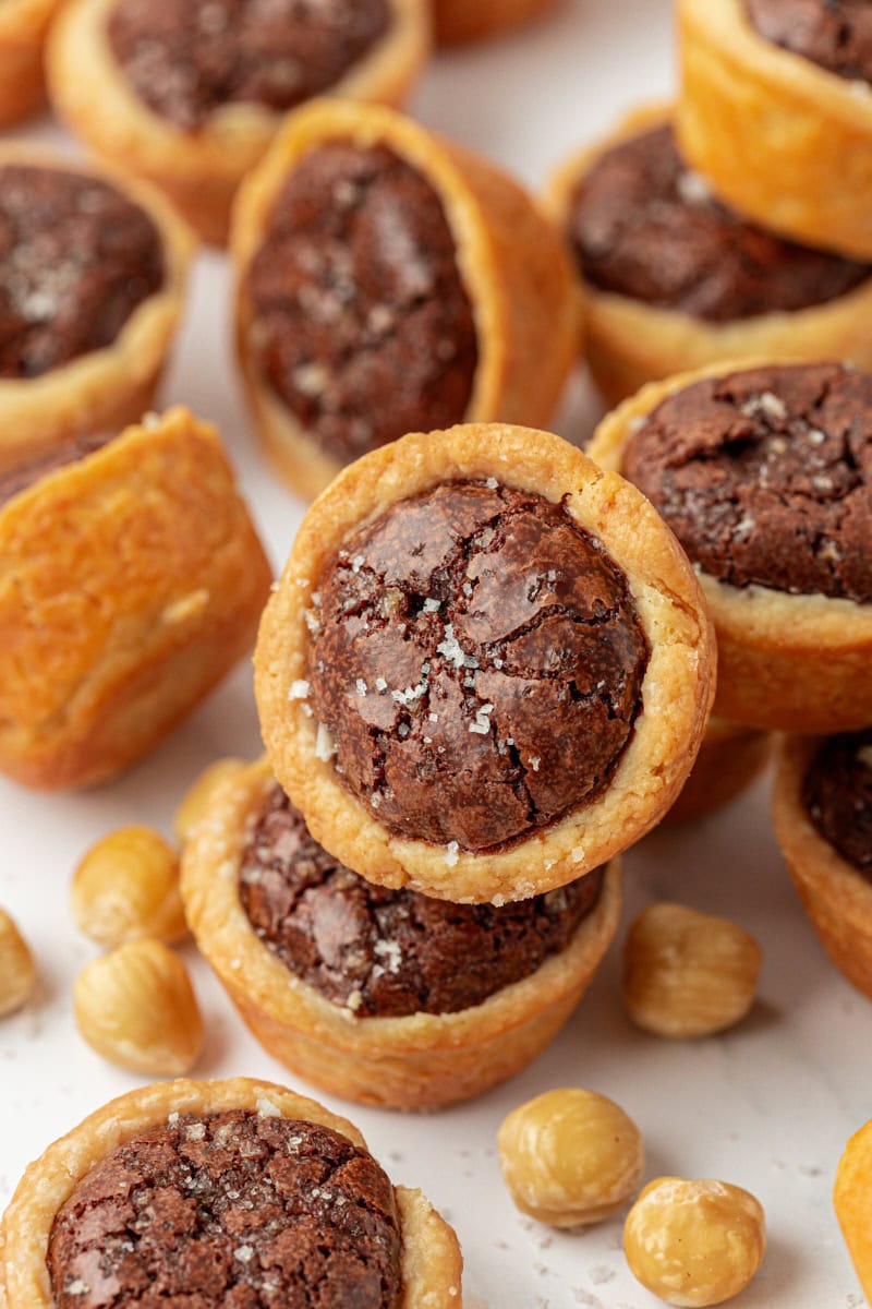 brownie tassies piled on a white plate