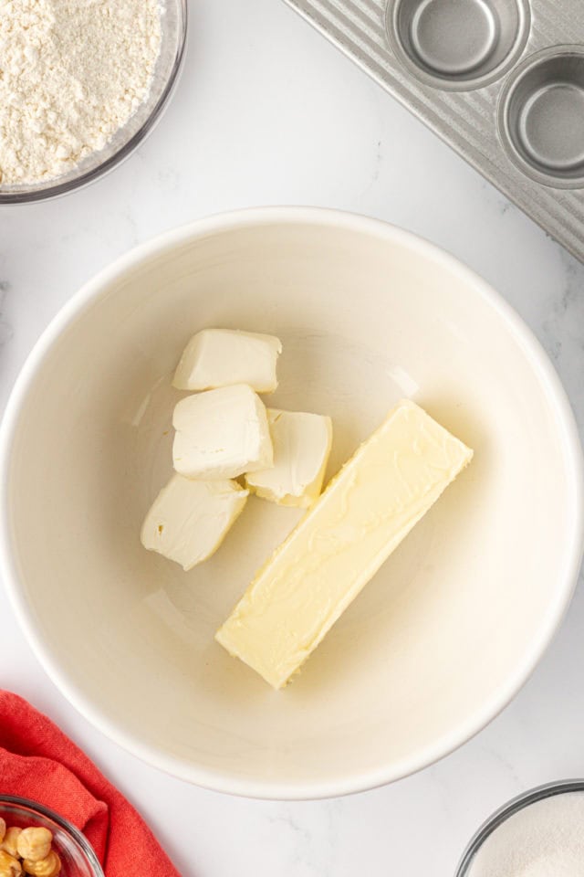 overhead view of butter and cream cheese in a mixing bowl