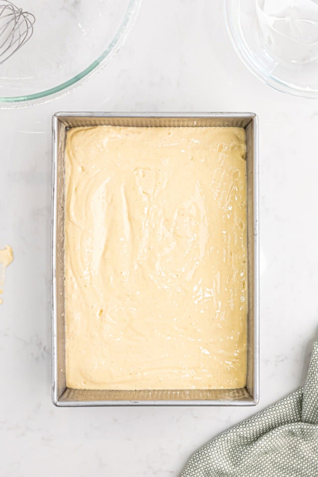 overhead view of tres leches cake batter spread in a 9x13-inch pan