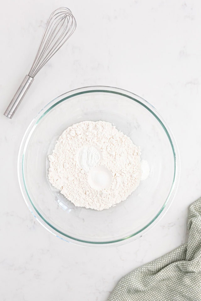 overhead view of flour, baking powder, and salt in a mixing bowl