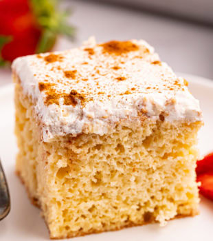 a slice of tres leches cake on a white plate