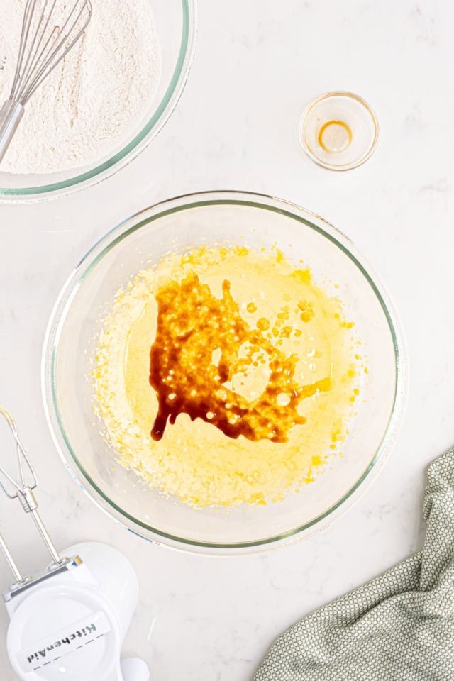 overhead view of vanilla and milk added to egg/sugar mixture