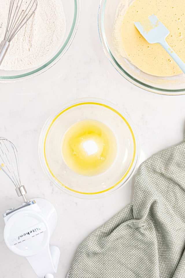 overhead view of egg whites and sugar in a mixing bowl