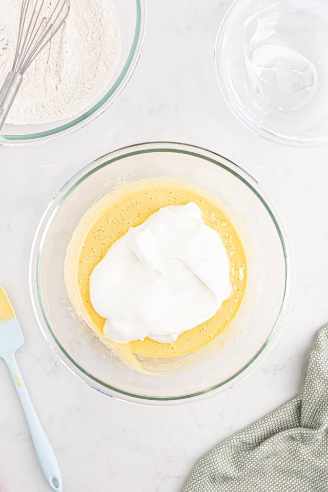 overhead view of egg white mixture added to egg yolk mixutre