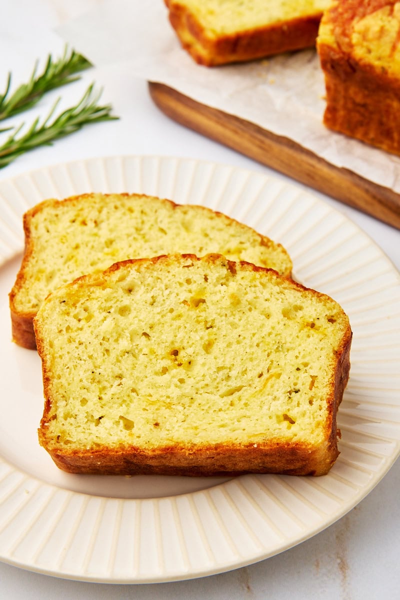 two slices of herb and cheese quick bread on a plate