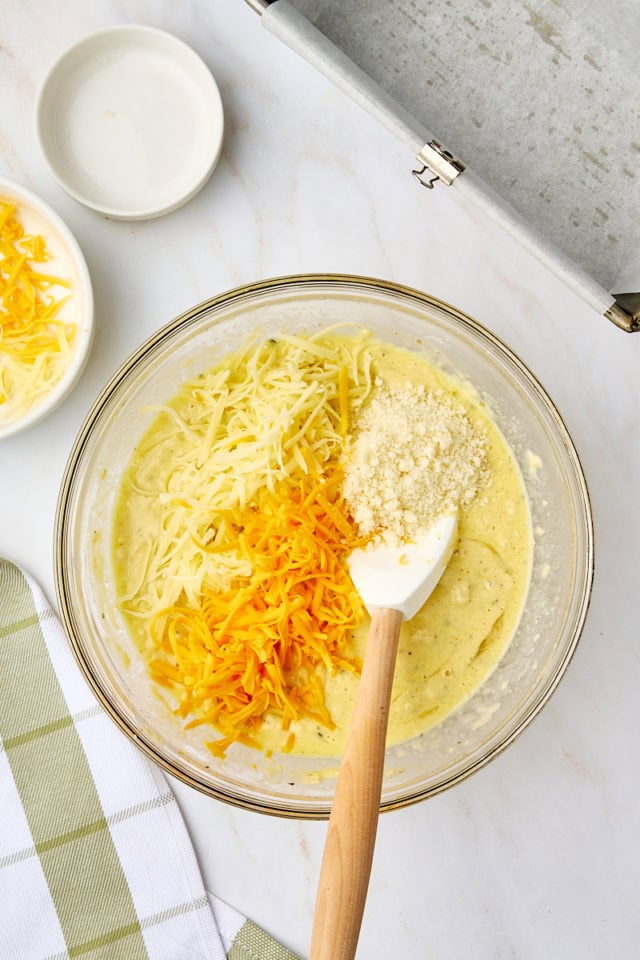 overhead view of cheeses added to herbed quick bread batter